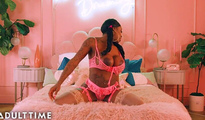 Ebony Mystique is posing in pink lingerie and masturbating