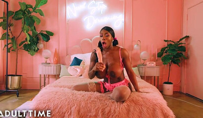 Ebony Mystique is posing in pink lingerie and masturbating